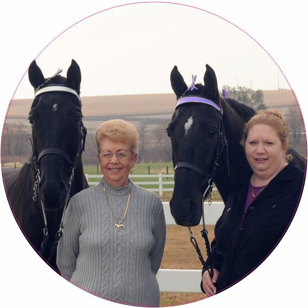 Mae Maack and Jennifer Maack-Condren stand beside their horses.