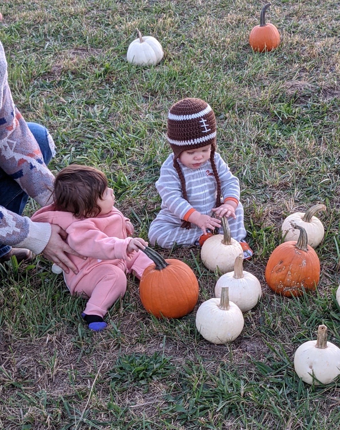 Hadley Phillips and Brody Swortwood play with pumpkins.