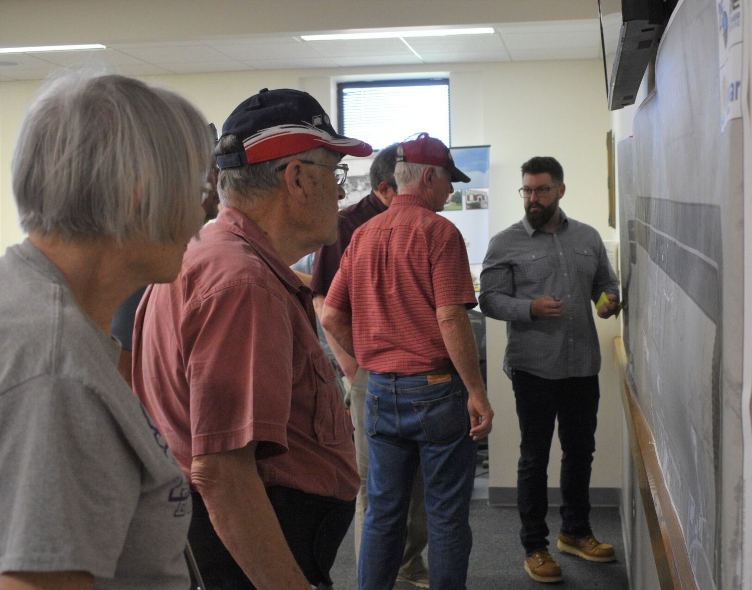 Garen McElroy, Transportation Team Leader with Great River Engineering, at right, speaks with community members during an open house for the East Loop Road project at Bolivar City Hall in June.