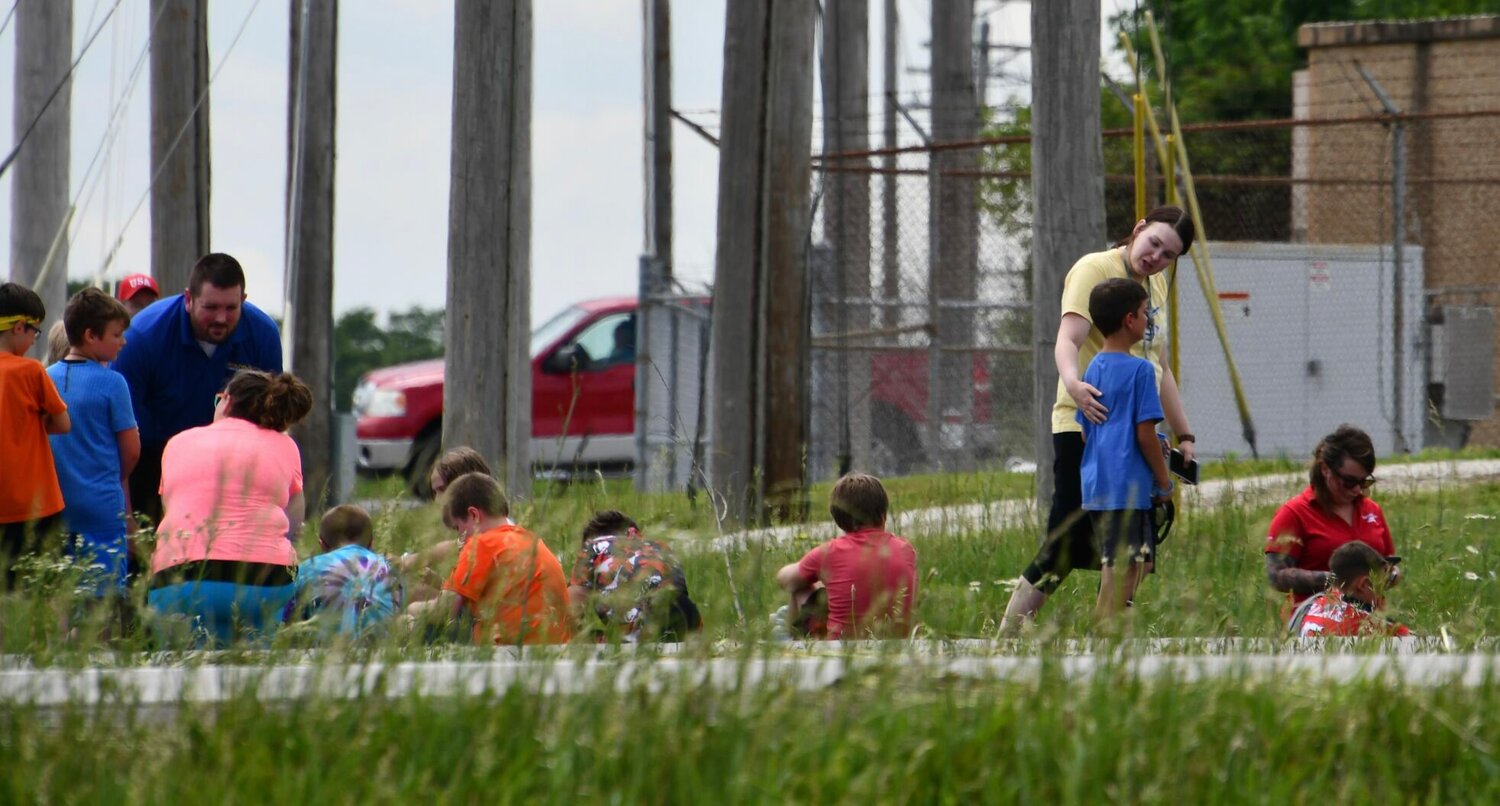 After evacuating the bus, third-graders waited next to the roadway while school staff and emergency responders assessed the situation and made plans to reunite the non-injured children with their families.
