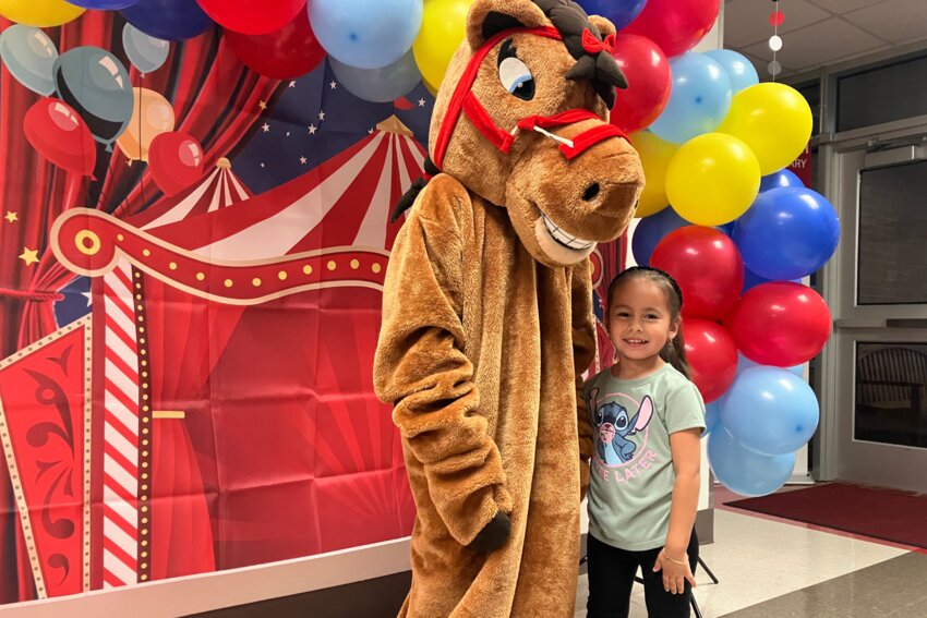 Mia Reyes (4) hugs CFBISD’s friendly mustang mascot.