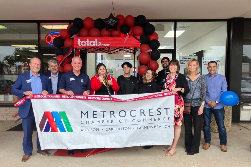 Monica Cruz (center), district manager of Total by Verizon, with representative Chiraag Tiwari and store manager Selina Suarez(right,) cuts the ribbon at the store’s grand opening Wednesday, May 22, which was celebrated by Metrocrest Chamber of Commerce and Farmers Branch Mayor Terry Lynne. Pictured from left are Metrocrest Chamber President Michael Gallops, Vincent Montengro, Lynne, Cruz, Tiwari, Suarez, Inderdeep Rana, Mary Ann Burns, Debra Krusehart and Jesse Castaneda.
(Photo by Kate Bergeron)