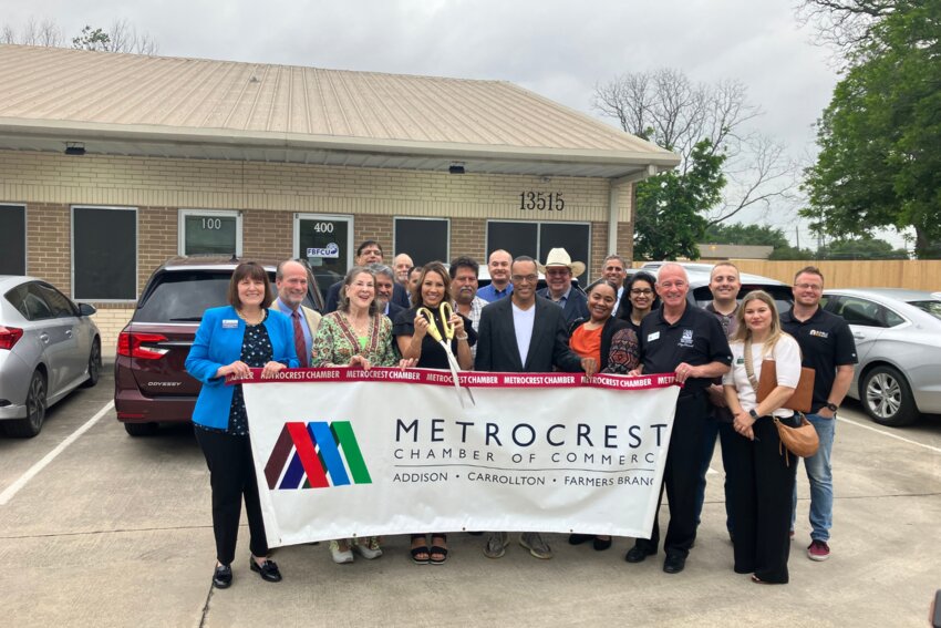 Audrey Hernandez cuts the ribbon with Suzanne Reynolds (left center) and Fabian Thomas (right center) to celebrate the FBFCU rebranding efforts.
(Photo by Kate Bergeron)