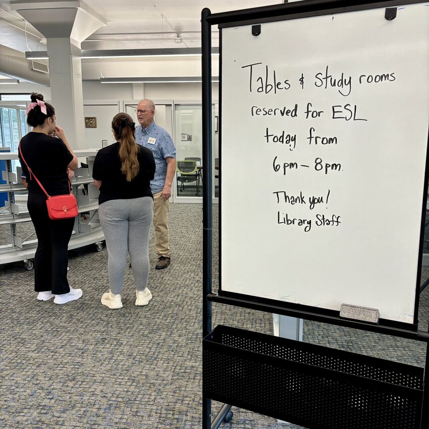 ESL instructor and volunteer Cliff Starnes welcomes students before class at the Farmers Branch Manske Library.