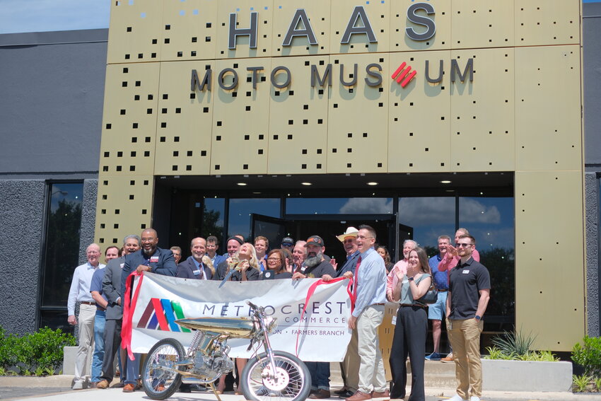 Museum Director Stacey Mayfield cuts the red ribbon alongside her team, city officials and members of the Metrocrest Chamber of Commerce.