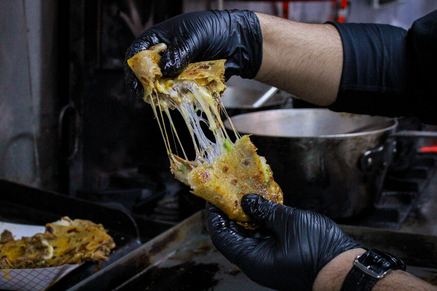The cheese pull of the nihari birria quesadilla.