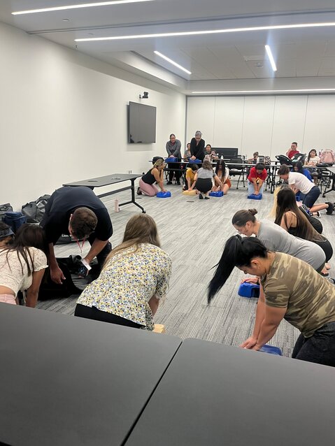 A room full of participants learn CPR during a Hope Cottage parenting class.