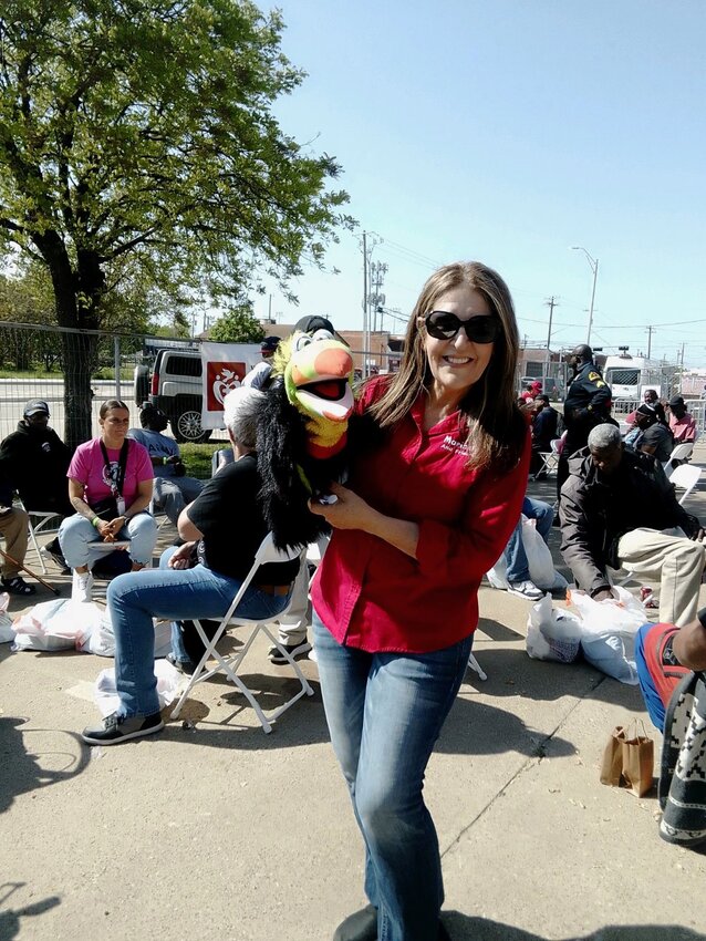 Maricela Carelock poses with one of her puppets, Mango, on April 12, as they worked with Operation Care International, a faith-based non-profit that primarily helps the homeless and those who are low-income.