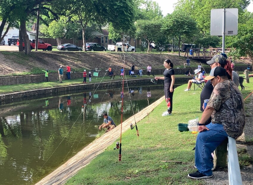 Cristina, Claudia and Edgardo Flores (from left) set their lines across from the rose garden on Rawhide Creek