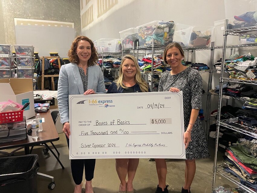Nancy H. Smith, I-66 EMP Director of Corporate Affairs, and Kirsten West, I-66 EMP Senior Communications Specialist, present Boxes of Basics Founder and Executive Director Sarah Tyndall with a check for $5,000.