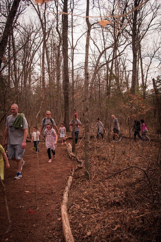 Residents take first walk through wooded path. 