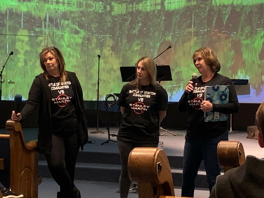 Donna Gallant, Laura Mahony and Bethany Kelley urge people to join their march against the Devlin Tech Park and speak at the Nov. 28 board meeting.