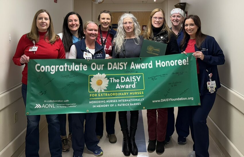 Rebecca Segal, FACHE, CEO; Toni Maxwell, APRN, FNP-BC, CNO; Michelle Amirato, RN; Hannah
Pedersen, RN; Jennifer Jo Kyte; Aprile VanBuecken, RN, DNP, MHSA; Shawna Cochran Breeden, MSN,
RN, CNOR; and Danielle Quesenberry, BSN, RNC-OB, C-EFM with the DAISY banner.