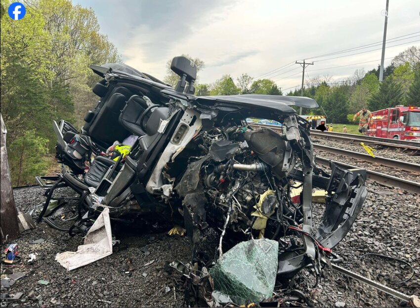 Emergency vehicles arrive on the scene of a collision between a truck and a train on Bristow Road, April 15.