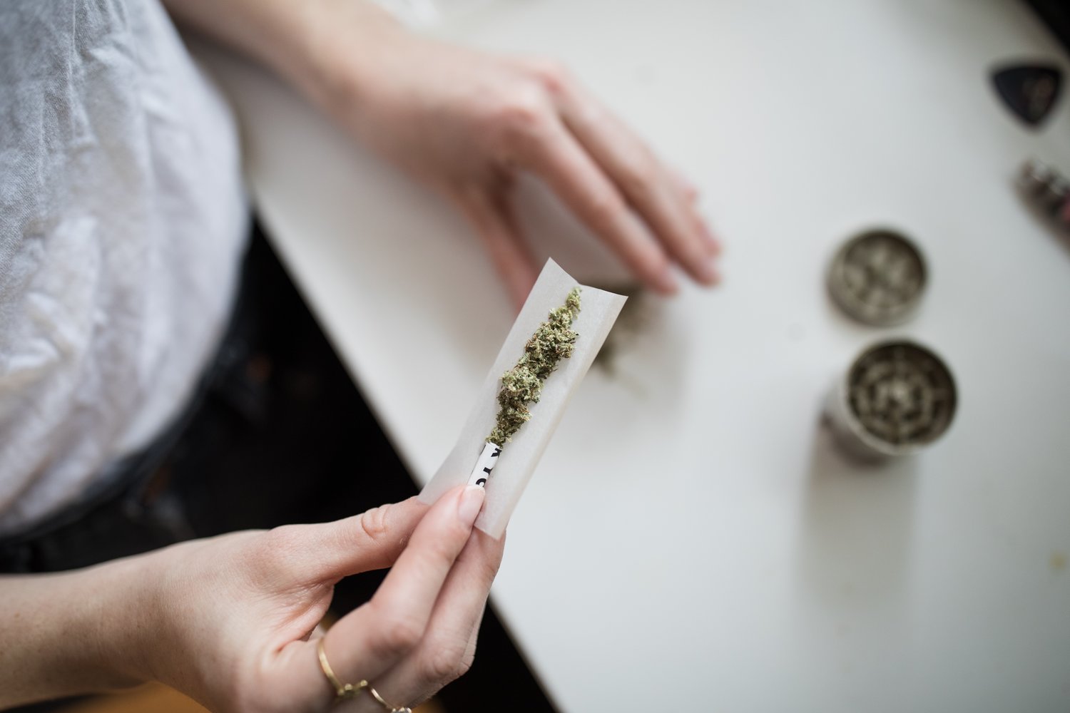 Woman rolls a marijuana joint