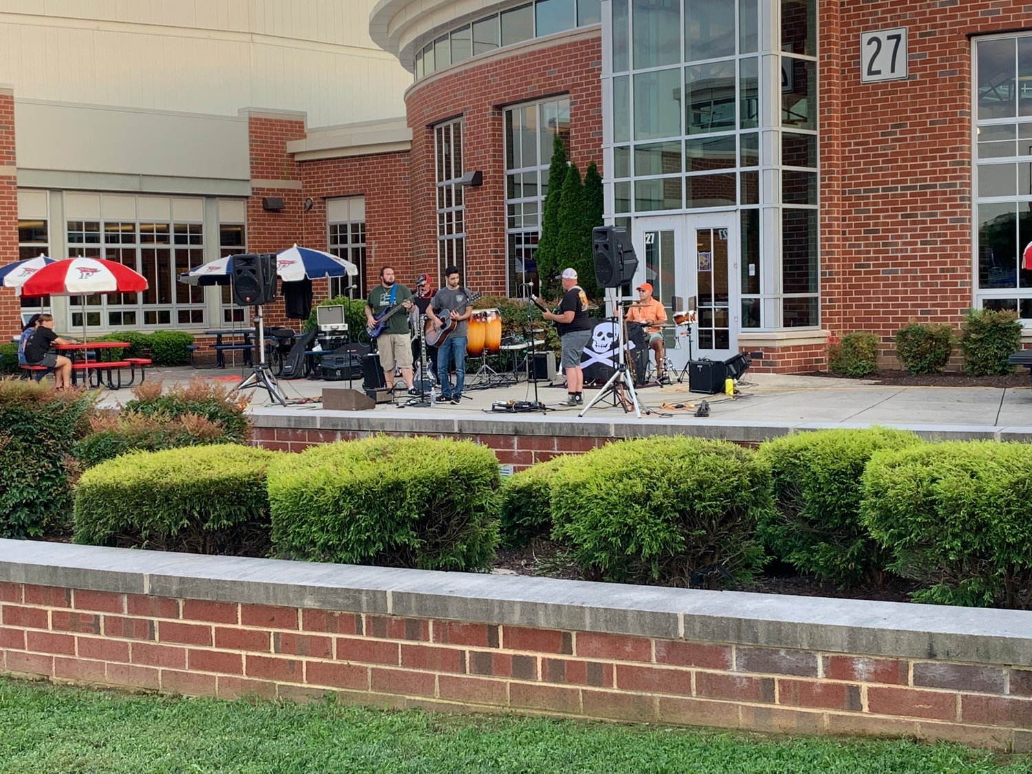 Band plays outside the school to entertain the attendees.