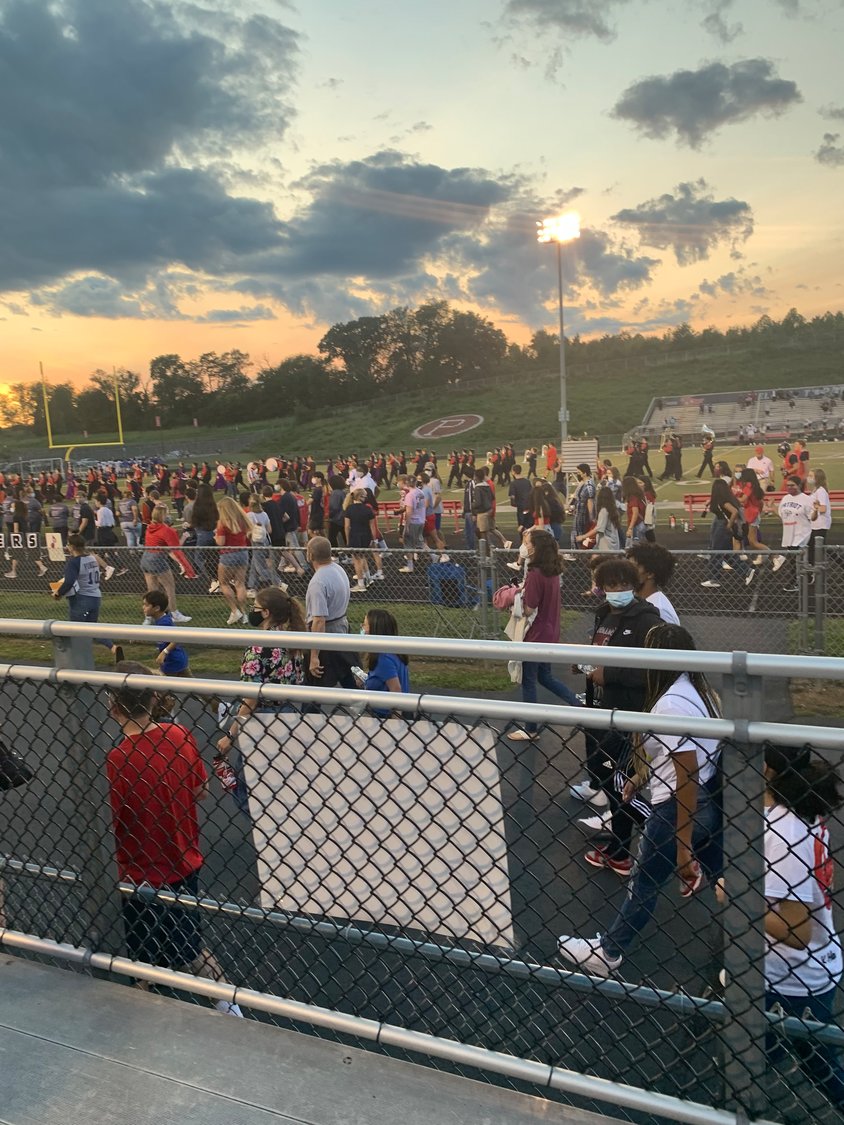 Students: band, cheerleaders and football players gather on the field. The school also recognizes VIP visitors and the custodians who have worked so hard over the past year.