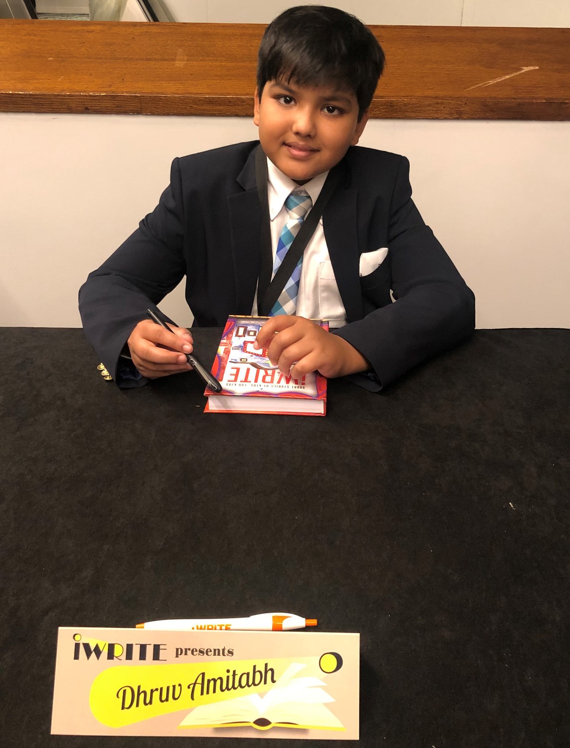Dhruv Amitabh signs copies of iWRITE's "Short Stories By Kids For Kids."