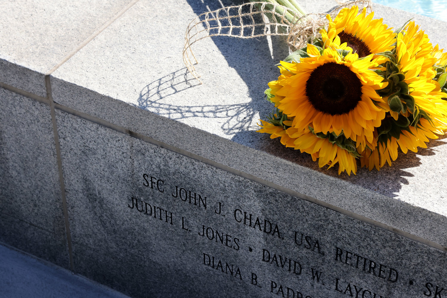 Flowers are placed on a memorial in honor of a Prince William County resident who died on Sept. 11, 2001.