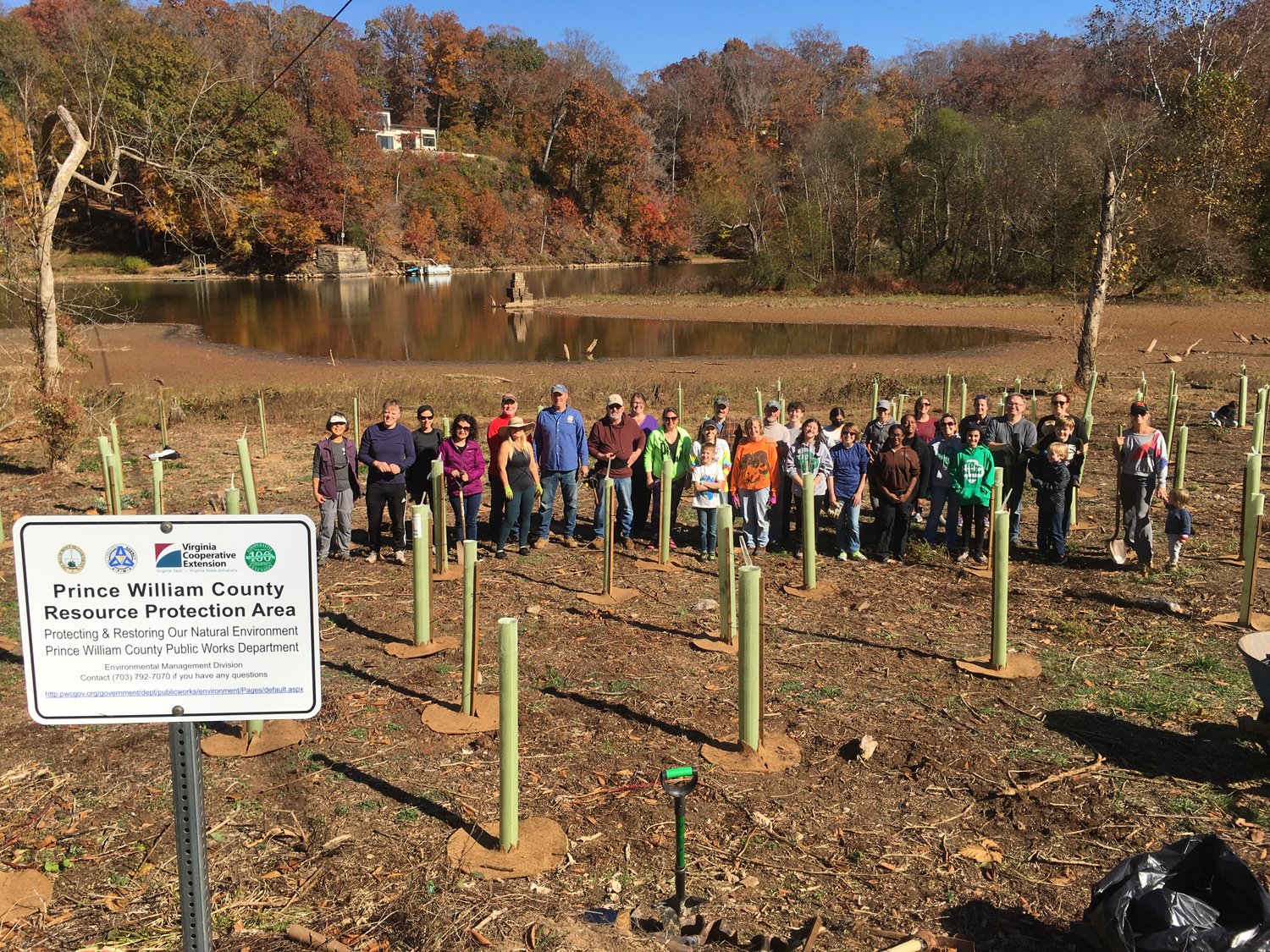 Volunteers gather to plant trees, flowers and other plants along the Occoquan.