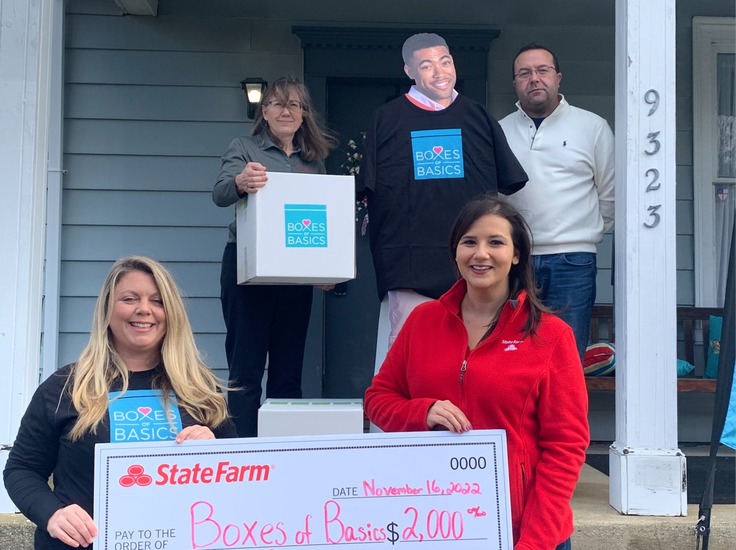 Jake of State Farm presents Boxes of Basics with a $2,000 check. Sarah Tyndall (front left) and Anita Sadlack (front right) with Sally Leigh of State Farm and Mike of Boxes of Basics.