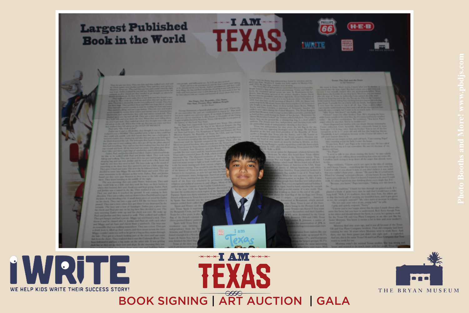 Darsh Amitabh, 10, stands in front of the 7+ foot book "I Am Texas," at the iWRITE awards conference.
