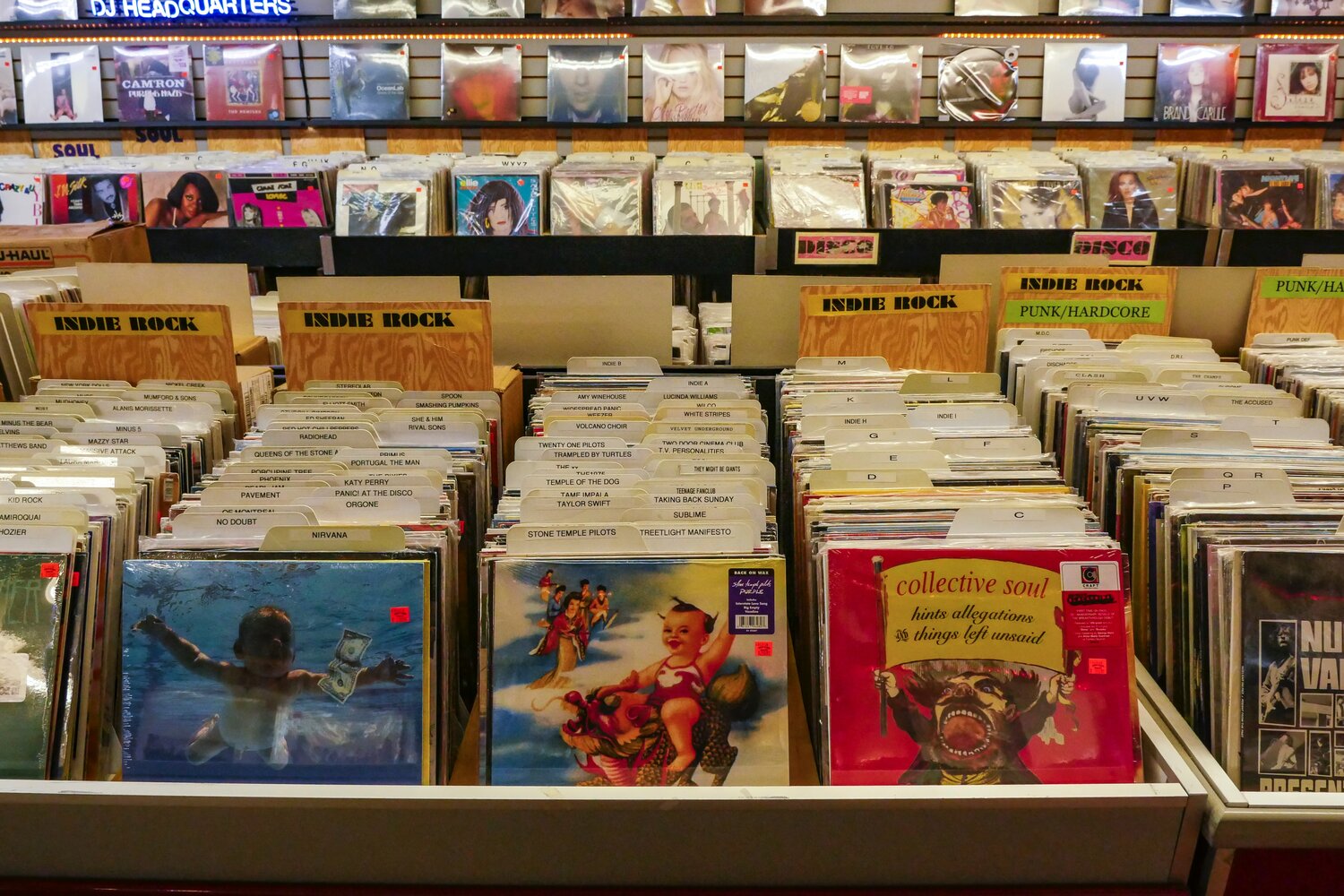 Alternative rock CDs from the 1990s are displayed in a record store.