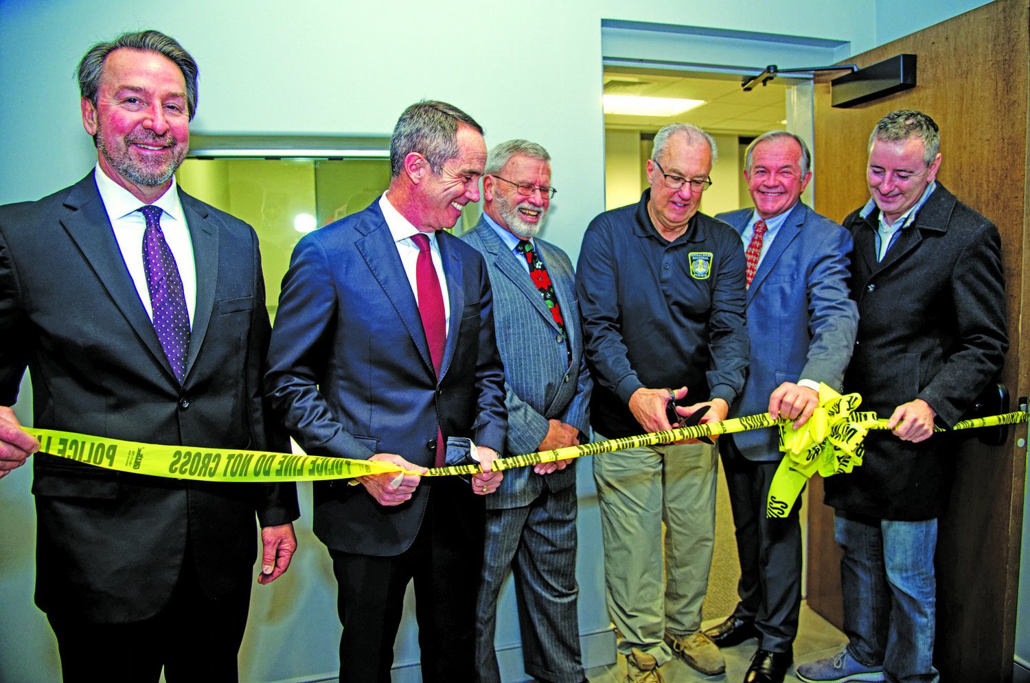 Officials gather as Chief Karl Knott cuts the ribbon to officially open the new Regional Police Headquarters in Doylestown. From left are Chalfont Mayor Brian Wallace, Sen. Steve Santarsiero, Mayor David Holewinski of New Britain Borough, Chief Knott, Doylestown Mayor Ron Strouse and Congressman Brian Fitzpatrick.