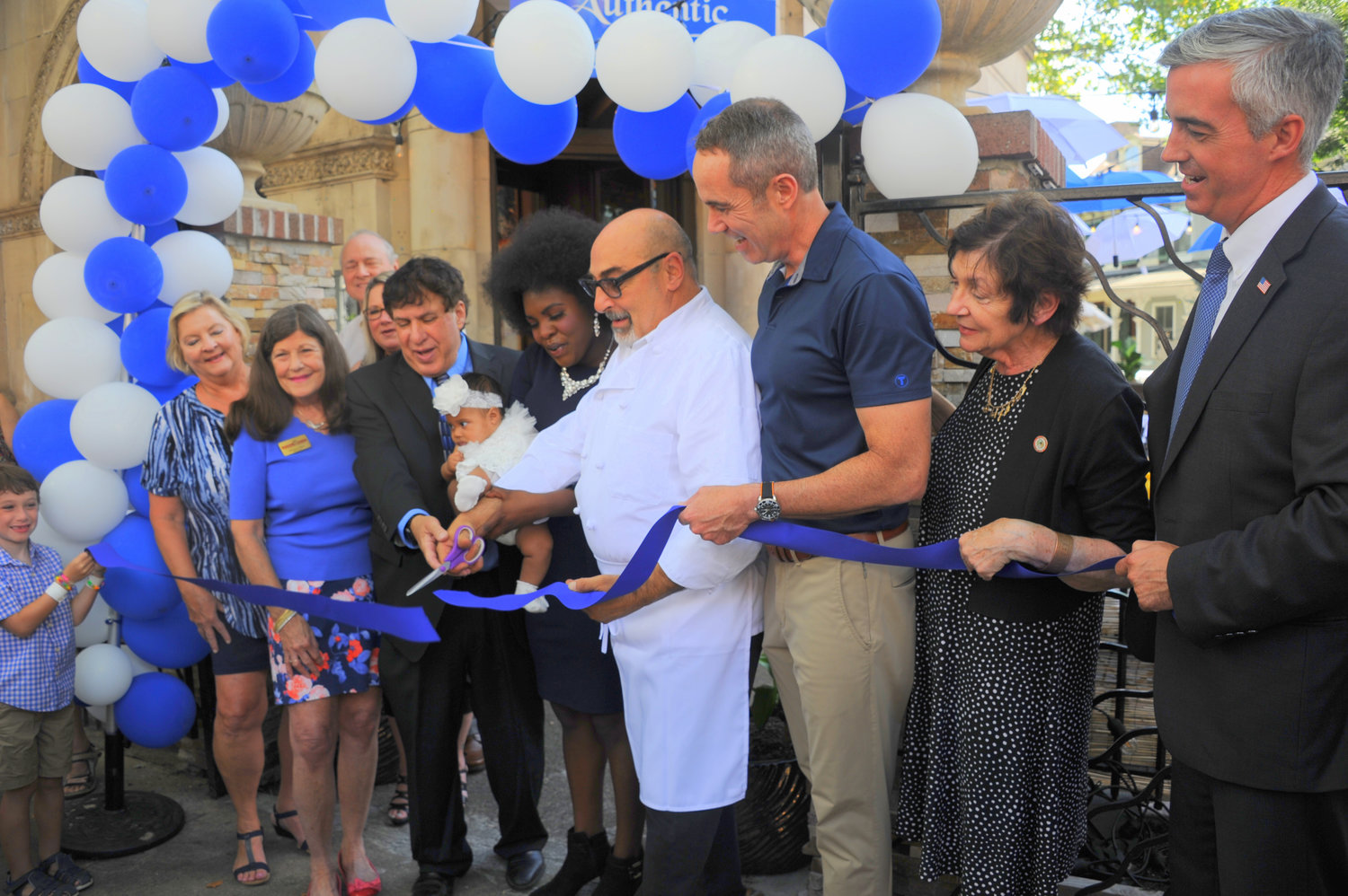 Susana, with baby Francesca, and Franco Federico, Matzah Balls Jewish Deli owners, cut the ribbon at Matzah Balls Jewish Deli’s grand opening Aug. 19 in downtown Doylestown. At right are state Sen. Steve Santarsiero, Mayor Noni West and Bucks County Commissioner Robert Harvie Jr.
