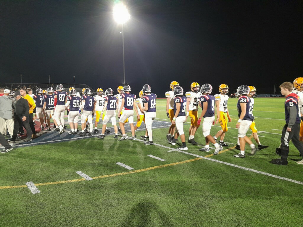 Central Bucks East and West players form a handshake line after the Bucks’ 42-26 District One Class 6A first-round playoff win last Friday.