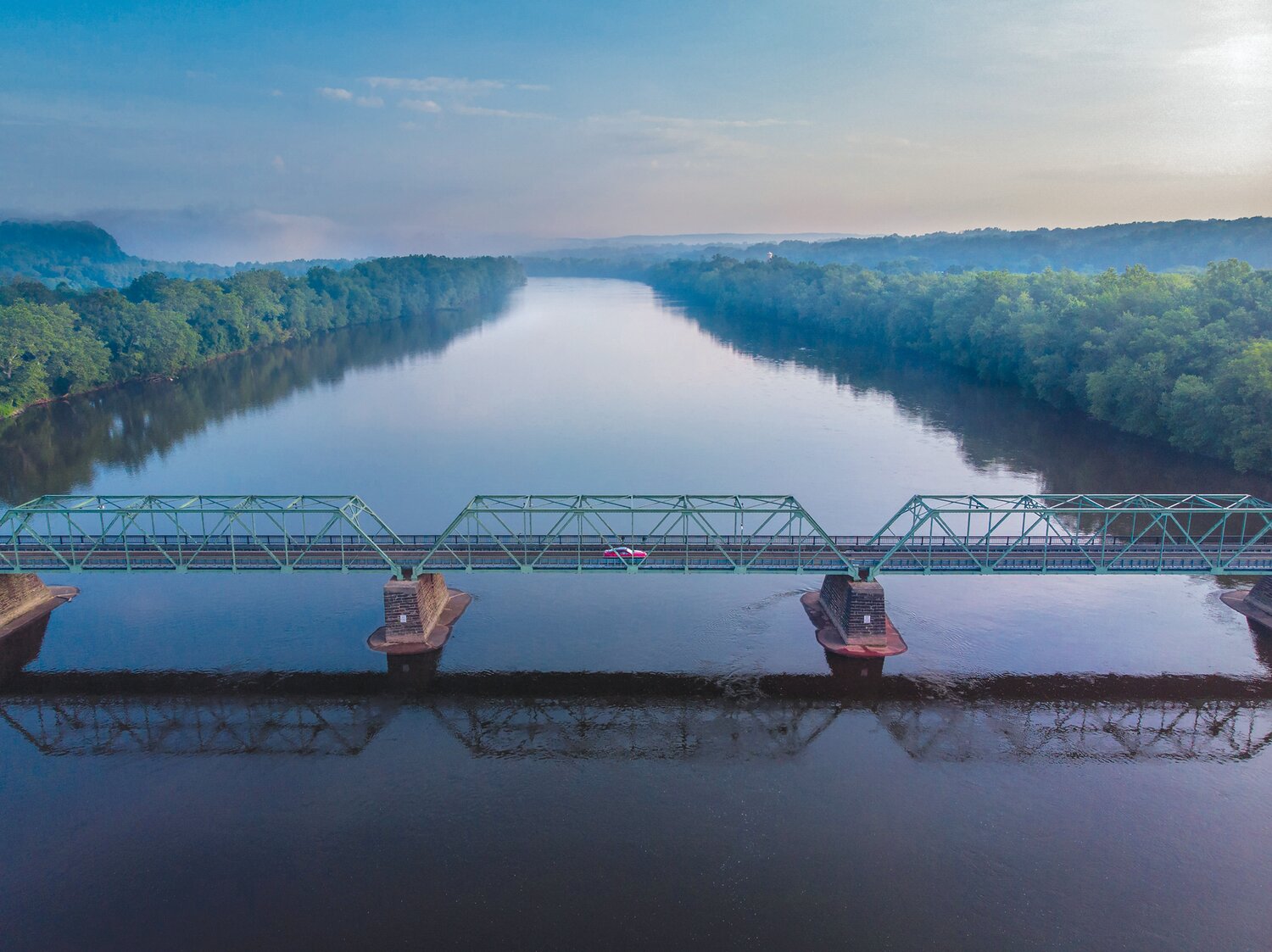 A single car traverses the Uhlerstown-Frenchtown Bridge over the Delaware River on July 20, 2019. We’re on the cusp of another Bucks County summer and the majestic Delaware is ready to welcome it to its beautiful shores.