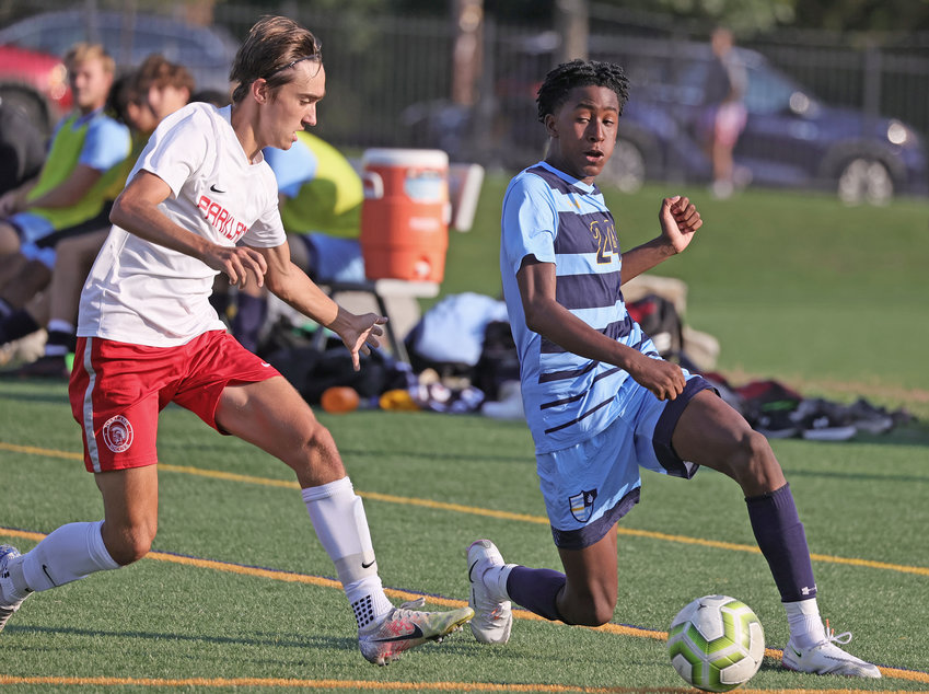 Controlling the ball on the left wing, SCH sophomore Zayd DeVeaux (right) senses the approach of a Parkland defender.