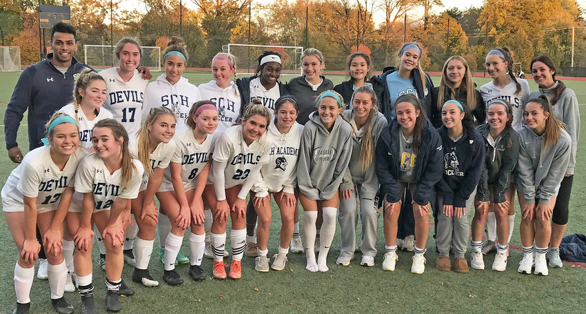 The girls of the SCH soccer team huddle in the fading light just after completing a 12-0 sweep in the Inter-Ac League with a victory at the Academy of Notre Dame.