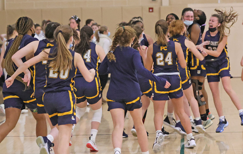 The Penn Charter players already on the court (right) are joined by the rest of their teammates as the final horn sounds at Notre Dame last Tuesday, signaling a major victory for the Quakers. (Photo by Tom Utescher)