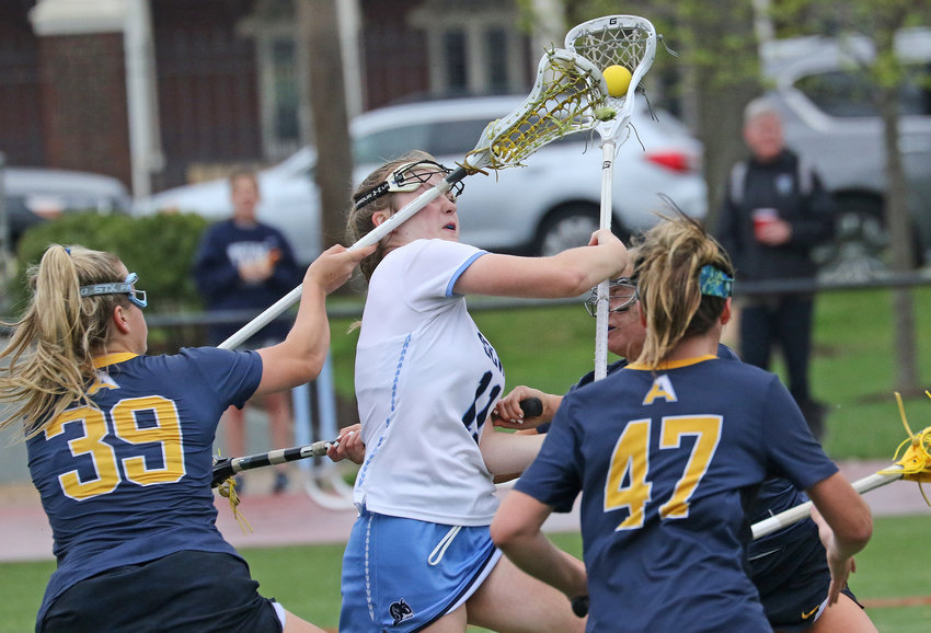 Blue Devils junior Emma Bradbury (white jersey) is hit from several sides as she tries to penetrate the Agnes Irwin defense.&nbsp; Photo by Tom Utescher