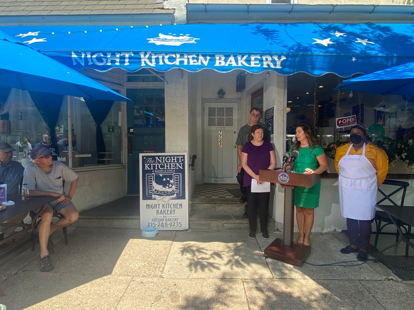Pennsylvania Secretary of Labor and Industry Jennifer Berrier speaks at a press event in front of Chestnut Hill&rsquo;s Night Kitchen Bakery &amp; Cafe as co-owners Amy Edelman and husband John Millard stand to her right. Employee Turquoise Affel stands to Berrier&rsquo;s left.