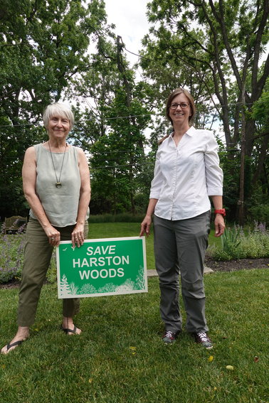 Friends of Harston Woods member Ellen Stevenson of Flourtown (left) stands with Alexandra Klinger, who is the president of Springfield Open Space, displaying one of the few Save Harston Woods yard signs left. Stevenson said if there is demand, the group will reorder more yard signs.