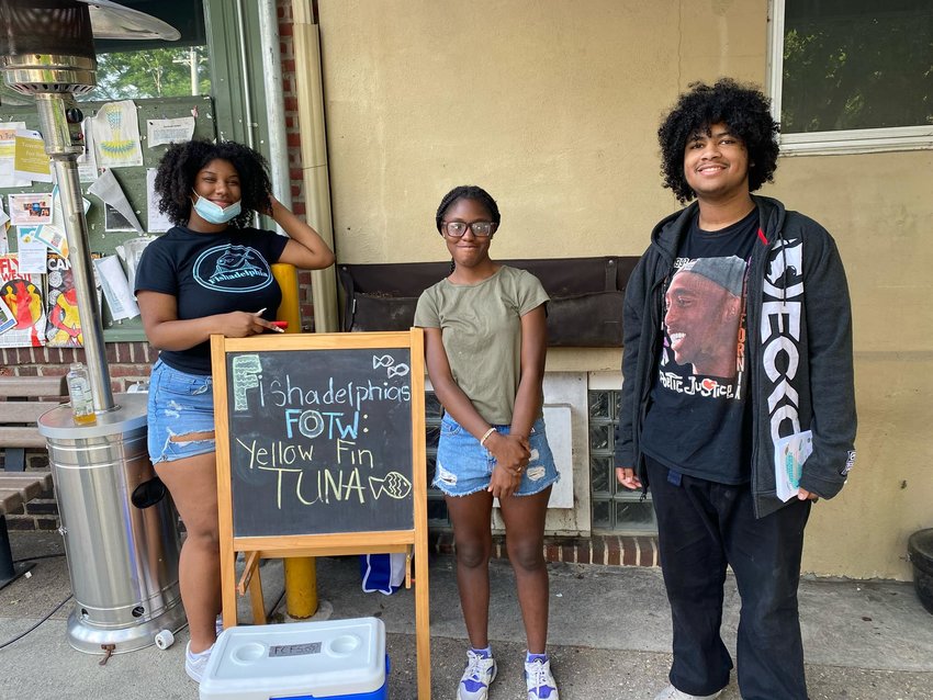 Students from Fishadelphia's after-school program set up their stand outside Mt. Airy's Weavers Way.