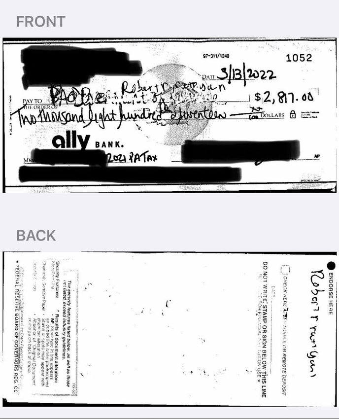 This redacted photo of a check written to the PA Department of Revenue shows that original words have been clumsily scribbled out and replaced with a name beginning with &ldquo;Robert.&rdquo;