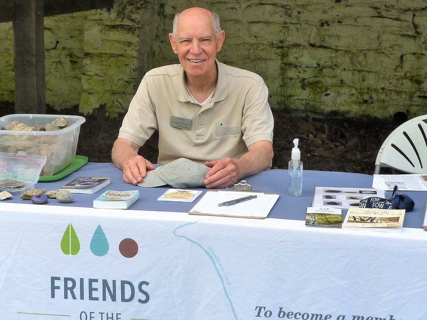 Friends of the Wissahickon trail ambassador James Charnock, 81, works the outreach table at Valley Green Inn, recruiting new members for FOW earlier this year.