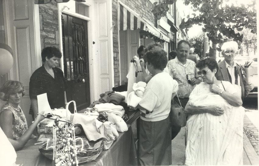 In a photo from the 1960s, Royal Rummage sidewalk sale shoppers peruse merchandise displayed in front of the former Dorothy Bullitt shop on Germantown Avenue.