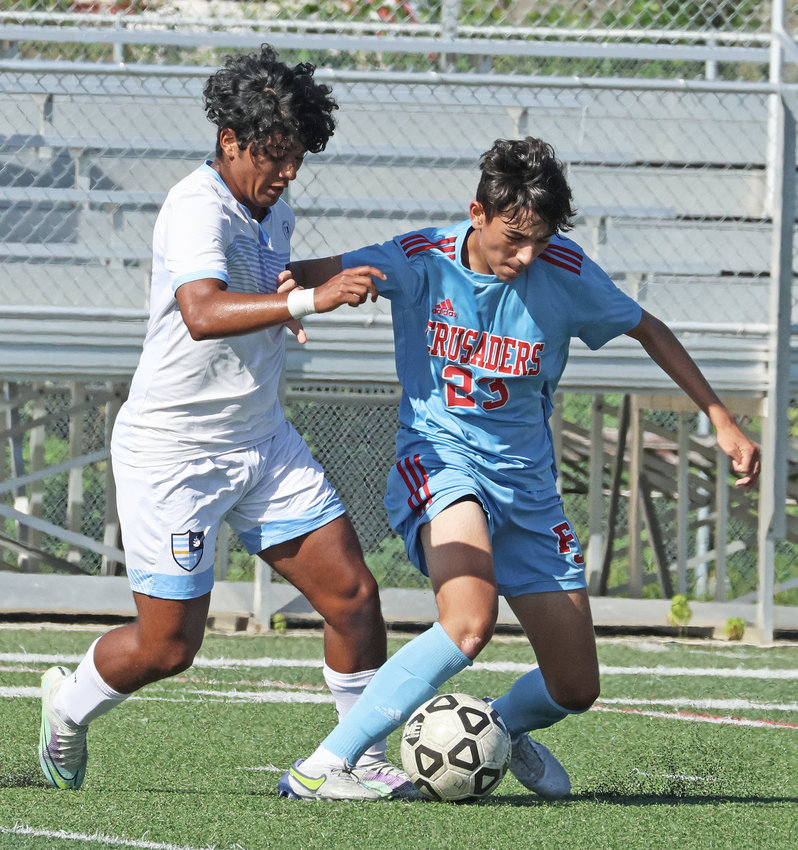 SCH senior Danny Heep (left) aims to take the ball away from Juan Ceciliano of Father Judge.