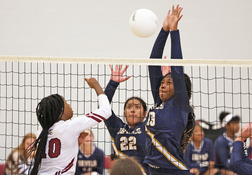 Juniors Kamaha'o Bode (center) and Zahkiyyah Frazier (right) defend the net in last week's match at ANC.