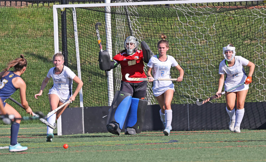 Blue Devils goalie Colleen Conlan urges on her teammates (from left) Caitlyn Melinson, Kerry O'Donnell, and Devyn Conlan as they charge out to counter a Merion Mercy penalty corner.
