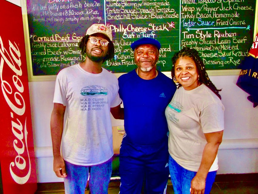 Jarrod Thomas (left) and his mom, Nicole (right) run the Mt. Airy Deli, 7200 Devon St., which was opened 27 years ago by Nicole&rsquo;s dad, Coker (center) and mom, Melanie.