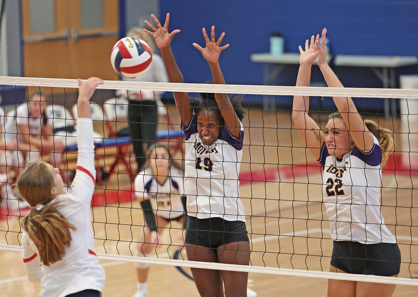 Rising up to block against a Plymouth Whitemarsh hitter are Mount sophomore Lauren Montgomery (center) and senior Daphne Mond (right).