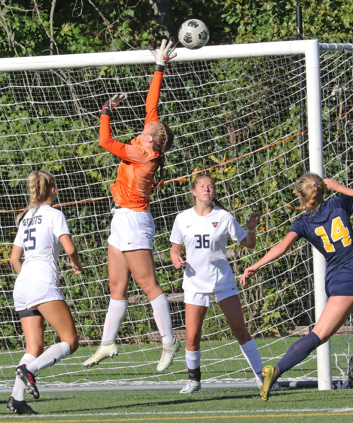 GA sophomore goalie Gabby Bowes tips the ball up over the crossbar as teammates Mia Raven (left) and Kayla Sweeney help defend on an Agnes Irwin corner kick.