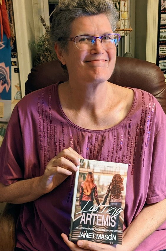 Author Janet Mason, a Mt. Airy resident for four decades, holds a copy of her just-released novel, &ldquo;Loving Artemis, An Endearing Tale of Revolution, Love and Marriage.&rdquo;