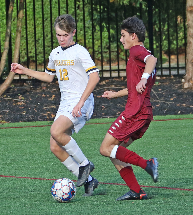 In the nick of time: Haverford's Nic Nekoumand (right) had been winding up for a long kick up the field, but PC junior Nick Kraemer stepped in to take the ball off his feet.