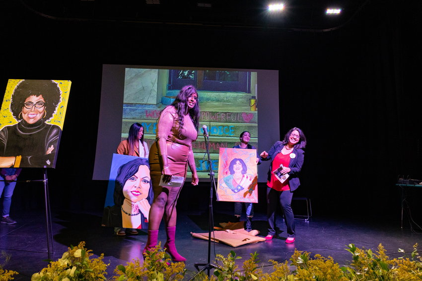 Nina Ahmad (far right), president of the Pennsylvania chapter of the National Organization for Women, at a get-out-the-vote event Sunday at Taller Puertorriqueno, a cultural organization and arts center based in Kensington. On the left is her collaborator, Zarinah Lomax. Standing at the back are Tanisha Serrano of N. Serrano Arts (left) and Billy Joe Michel of Trail Her Trash LLC (right).